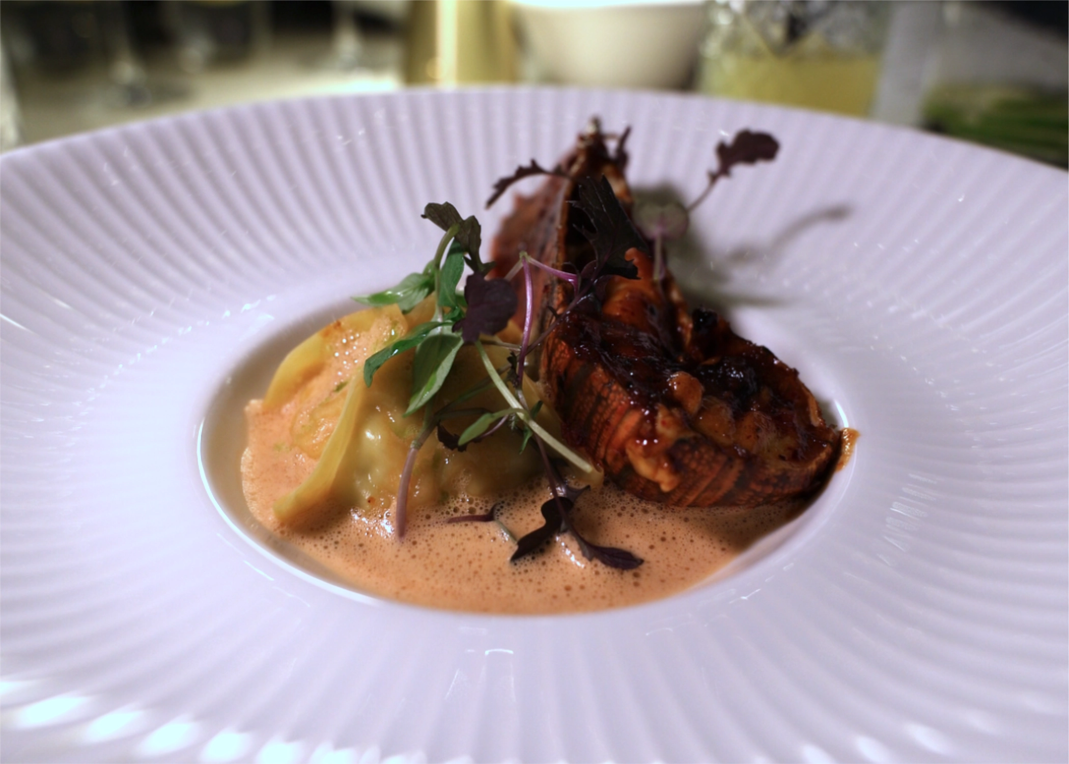 Grilled bay bug with dumpling in lobster bisque sauce