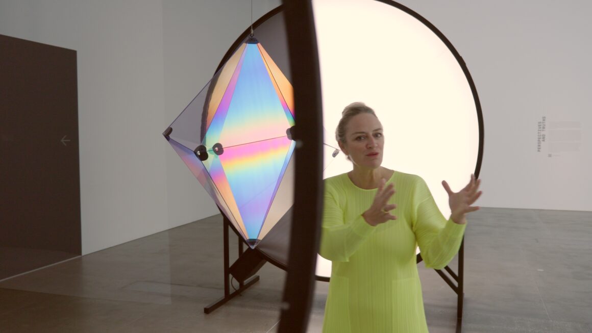 Curator Geraldine Barlow walking through the Olafur Eliasson Presence exhibition at QAGOMA Brisbane, discussing immersive light installations.