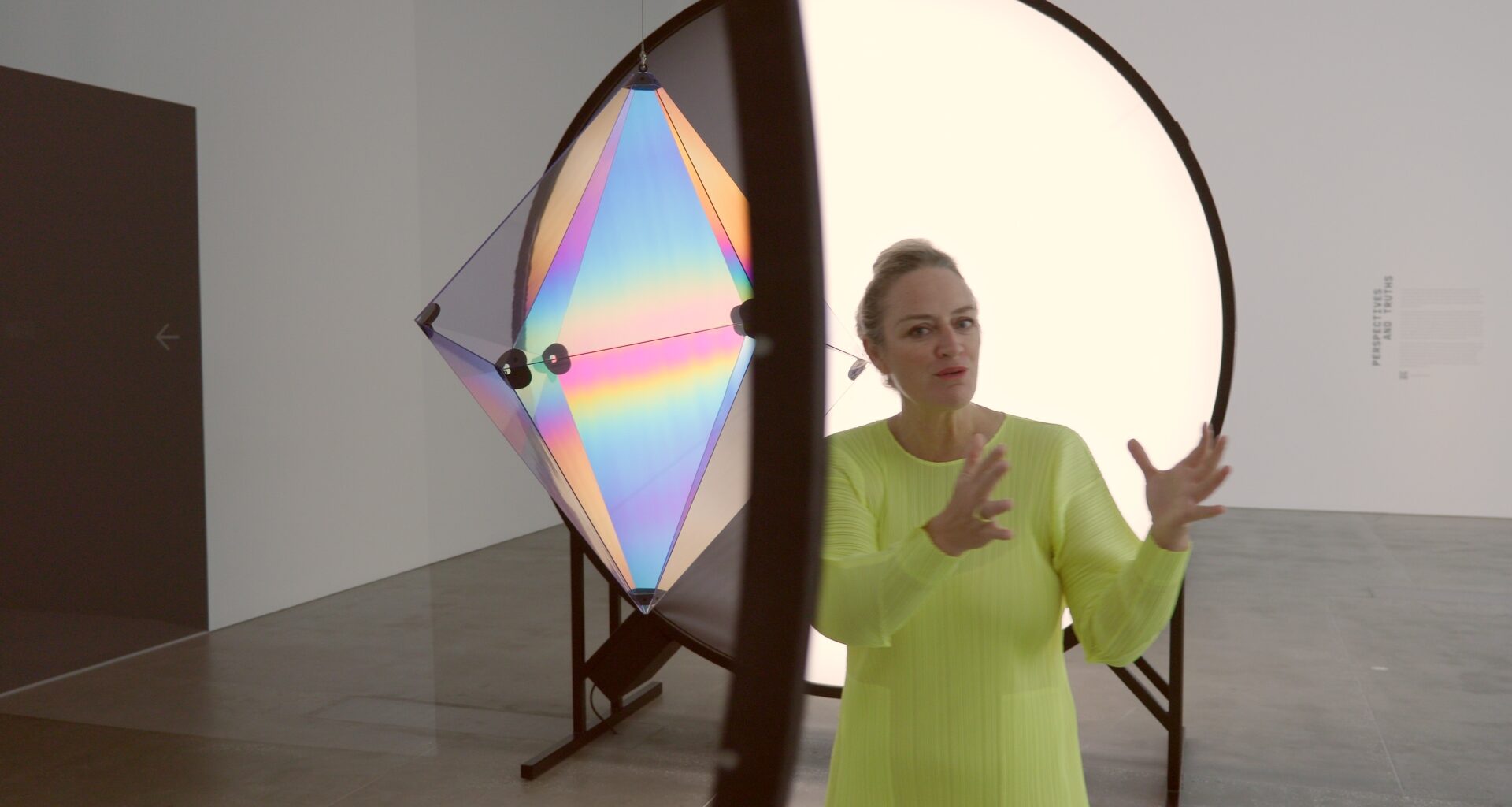 Curator Geraldine Barlow walking through the Olafur Eliasson Presence exhibition at QAGOMA Brisbane, discussing immersive light installations.