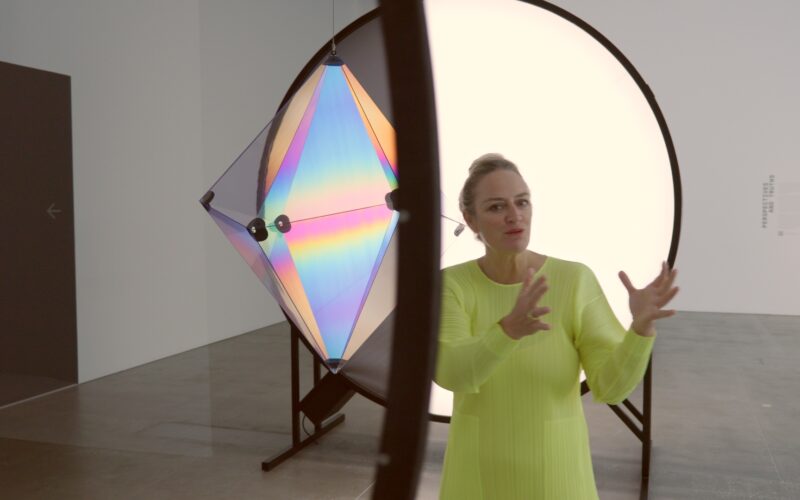 Curator Geraldine Barlow walking through the Olafur Eliasson Presence exhibition at QAGOMA Brisbane, discussing immersive light installations.