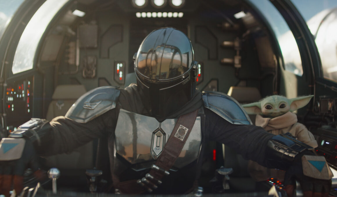 The Mandalorian Din Djarin and his apprentice Grogu in a scene from the Lucasfilm movie The Mandalorian and Grogu.