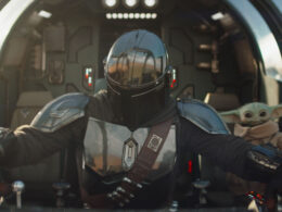 The Mandalorian Din Djarin and his apprentice Grogu in a scene from the Lucasfilm movie The Mandalorian and Grogu.