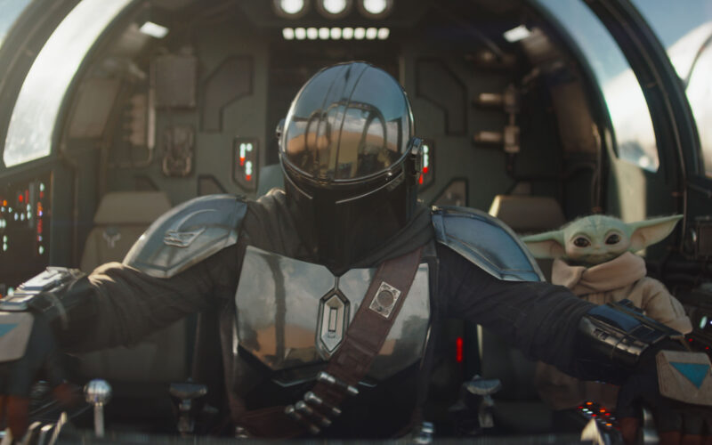 The Mandalorian Din Djarin and his apprentice Grogu in a scene from the Lucasfilm movie The Mandalorian and Grogu.